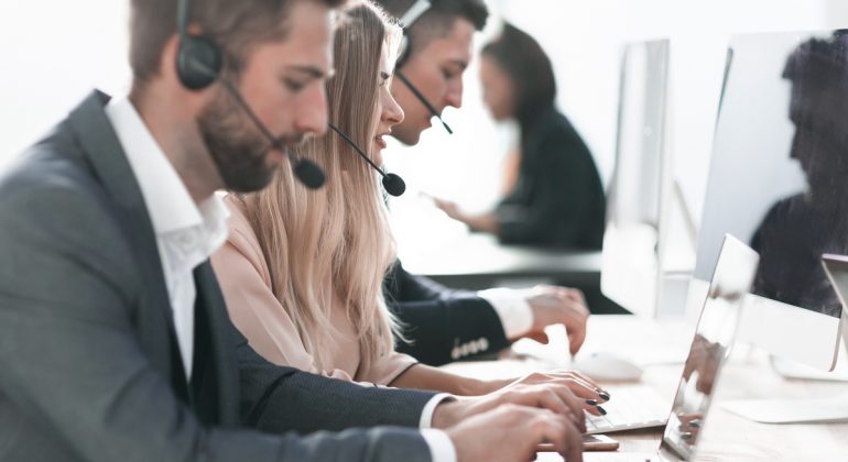 Call,Center,Operators,Using,Laptops,To,Work,With,Clients